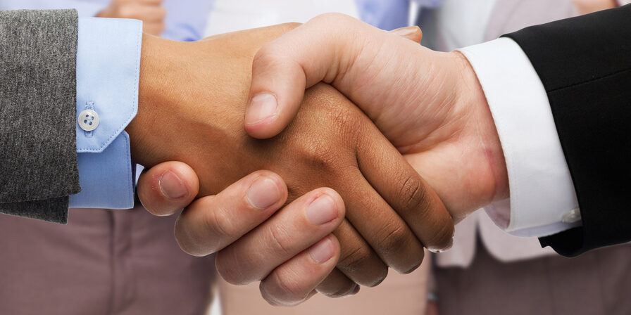 business and office concept - businessman and businesswoman shaking hands